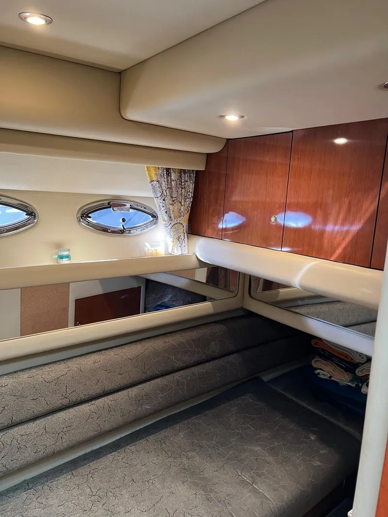 Slide: The Image of 2003 Sea Ray 480 Sedan Bridge interior with cozy cabin and elegant wood finish. - 46