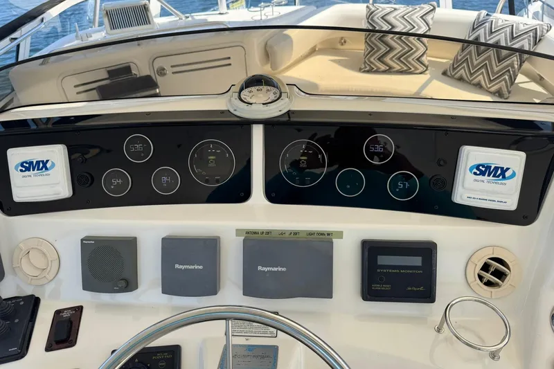 Slide: The Image of 2003 Sea Ray 480 Sedan Bridge dashboard with navigation and control systems, featuring Raymarine technology. - 53