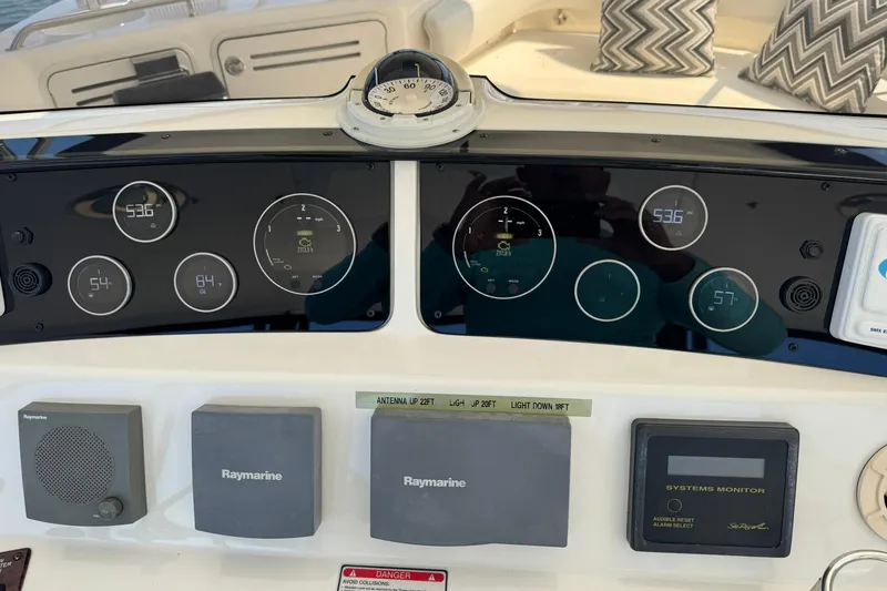 Slide: The Image of Control panel of a 2003 Sea Ray 480 Sedan Bridge yacht with navigation instruments. - 54