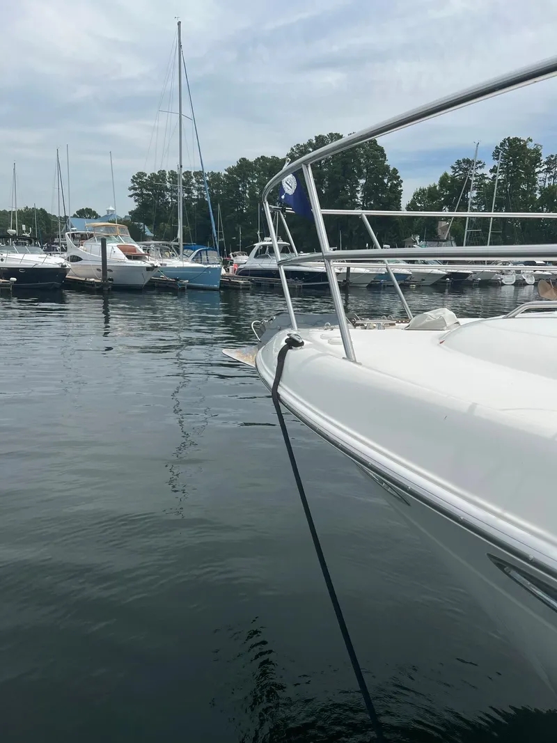 Slide: The Image of 2003 Sea Ray 480 Sedan Bridge docked in a marina with other boats. - 6