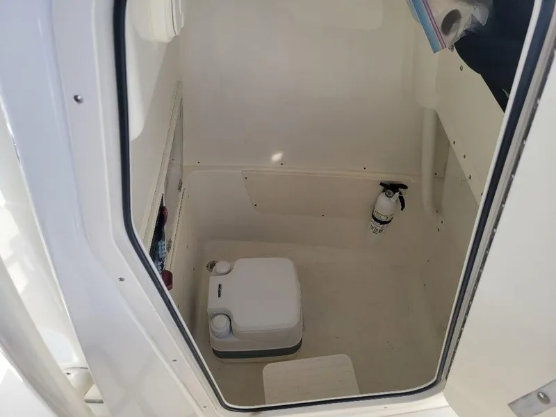 Slide: The Image of Interior of 2020 Mako 236 CC DUAL boat with portable toilet and fire extinguisher. - 10