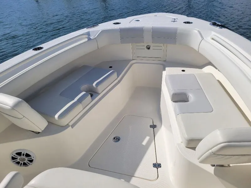 Slide: The Image of 2020 Mako 236 CC Dual boat interior with cushioned seating and storage compartments. - 6