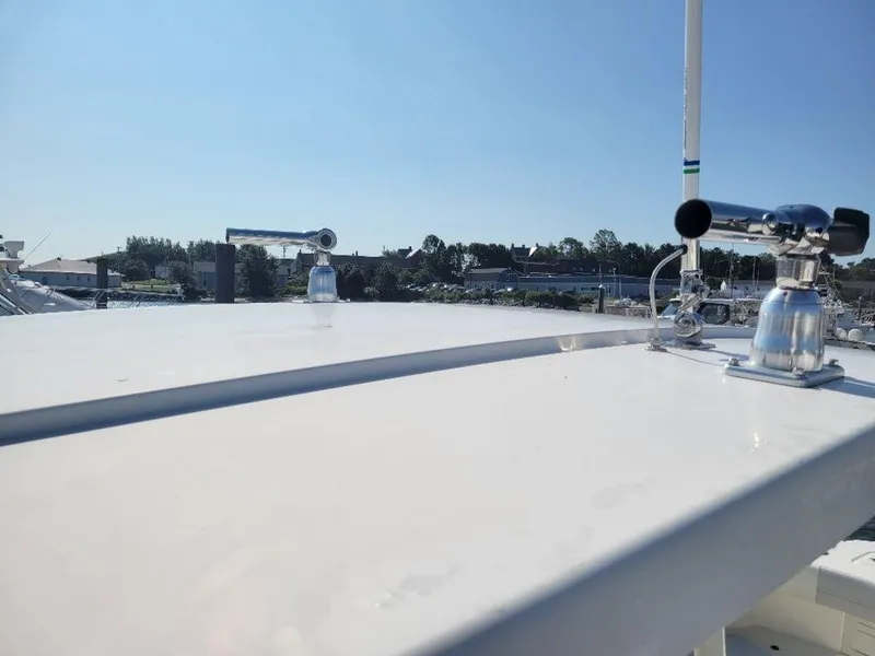 Slide: The Image of Mako 236 CC Dual 2020 boat roof with mounted equipment in a marina. - 9