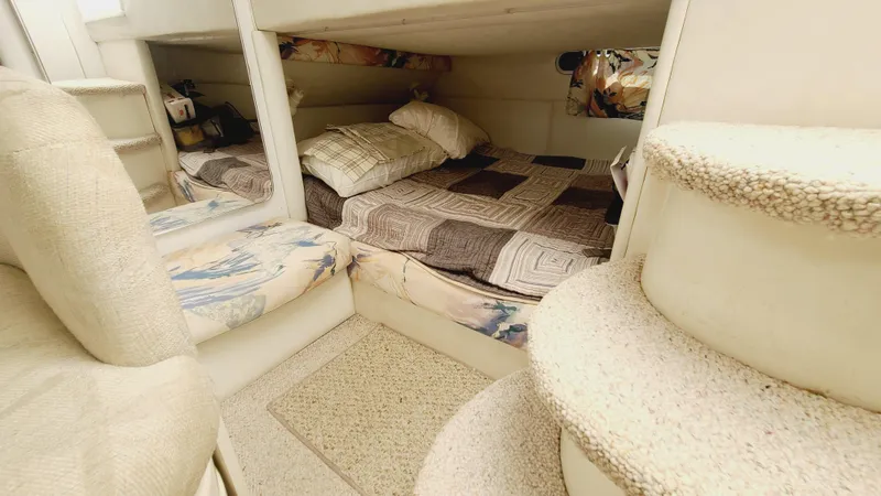 Slide: The Image of 1994 Larson 300 Cabrio cabin interior with bed and carpeted stairs. - 23
