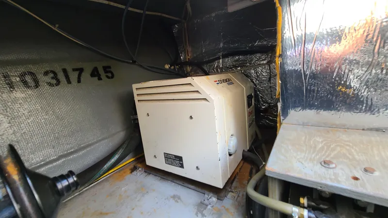 Slide: The Image of Engine compartment of a 1994 Larson 300 Cabrio boat with a generator. - 31