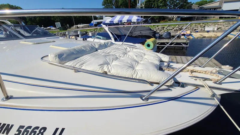 Slide: The Image of 1994 Larson 300 Cabrio boat docked with cushioned deck area. - 4