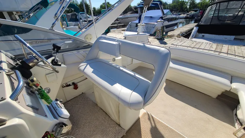 Slide: The Image of 1994 Larson 300 Cabrio boat interior with white seating and control panel. - 10