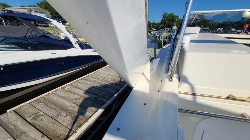 Slide: The Image of 1994 Larson 300 Cabrio docked at a marina on a sunny day. - 13