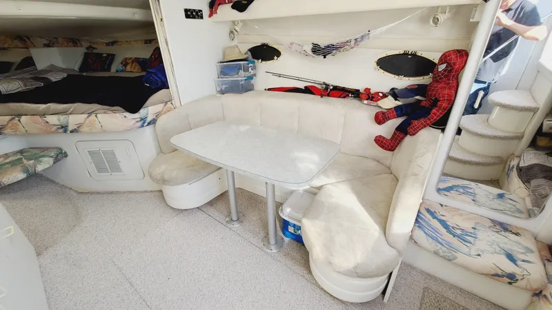 Slide: The Image of 1994 Larson 300 Cabrio interior with dining area and seating. - 18