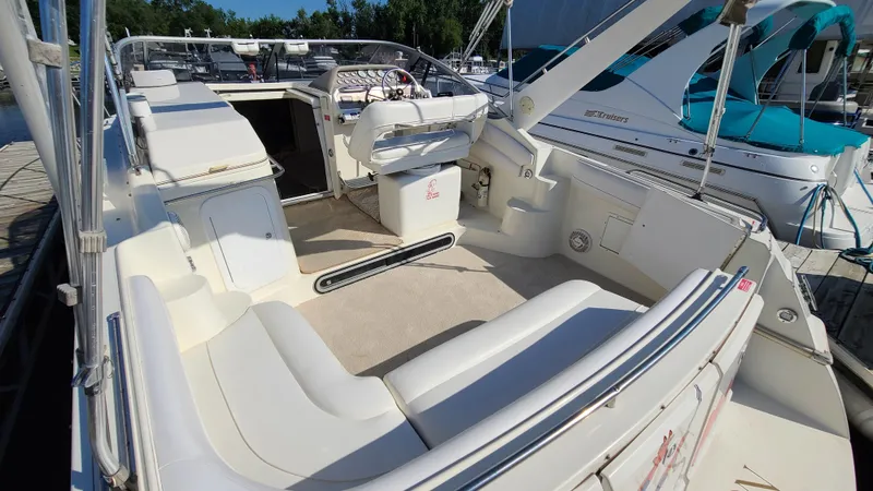 Slide: The Image of 1994 Larson 300 Cabrio boat interior with white seating and helm station. - 6