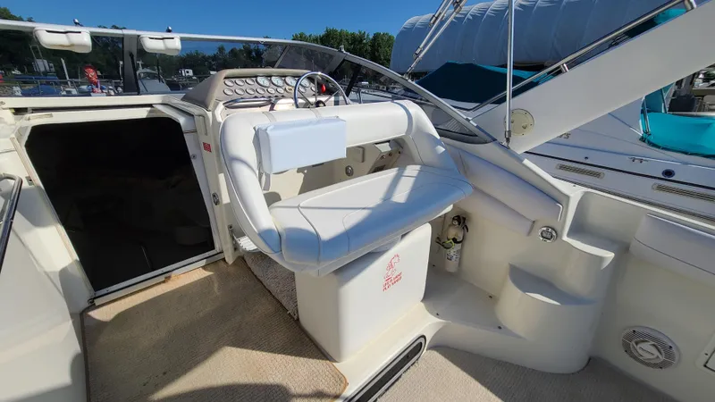 Slide: The Image of 1994 Larson 300 Cabrio boat cockpit with white seating and steering wheel. - 9
