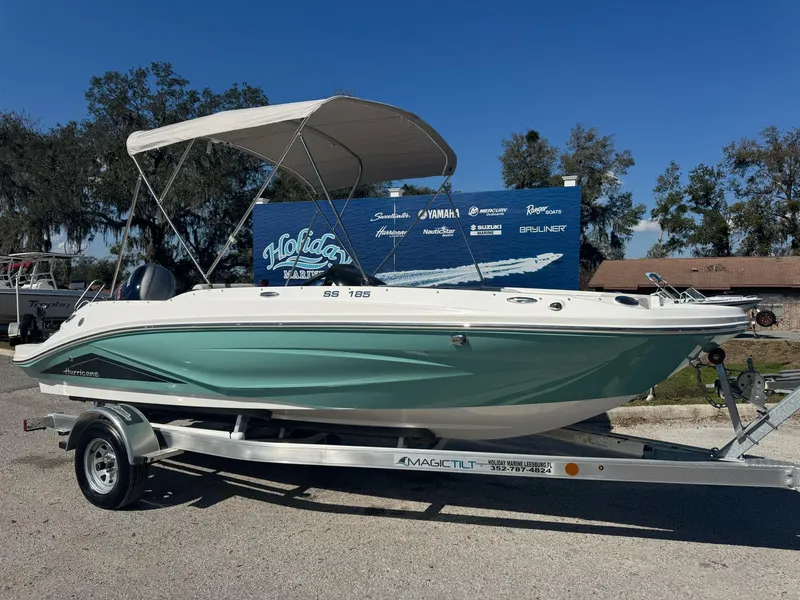 The Image of 2025 Hurricane SS185 boat on trailer, featuring a sleek design and canopy, parked outdoors. - 0