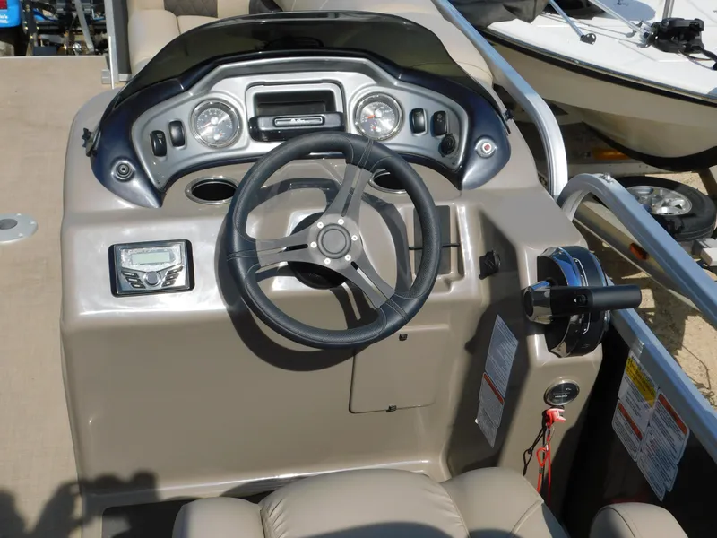 Slide: The Image of 2023 Sun Tracker Party Barge 22 RF DLX steering console with gauges and controls. - 18
