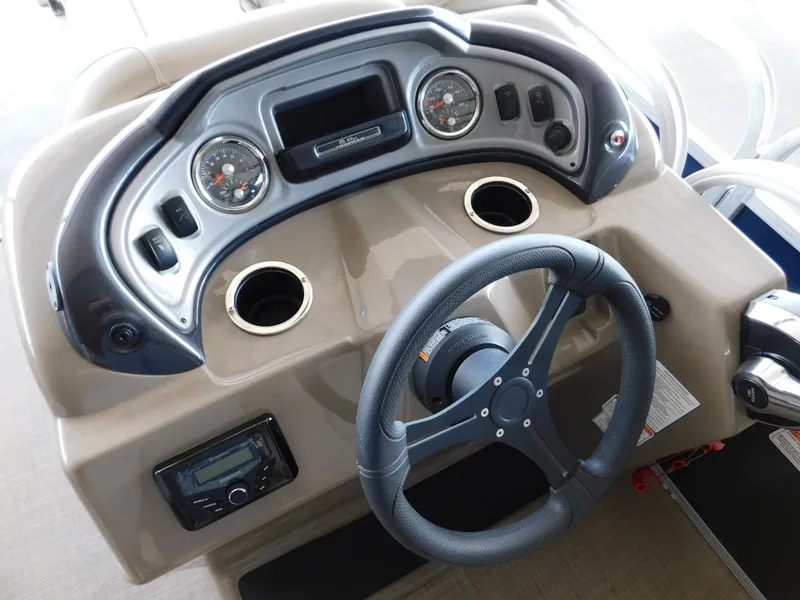 Slide: The Image of 2023 Sun Tracker Party Barge 22 RF DLX dashboard with steering wheel and instrument panel. - 3