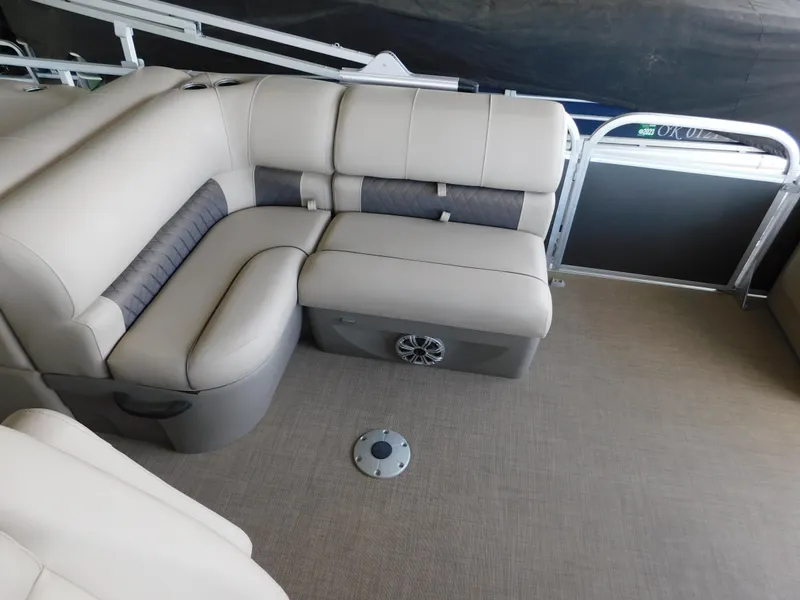 Slide: The Image of 2023 Sun Tracker Party Barge 22 RF DLX interior with beige seating and carpeted floor. - 5