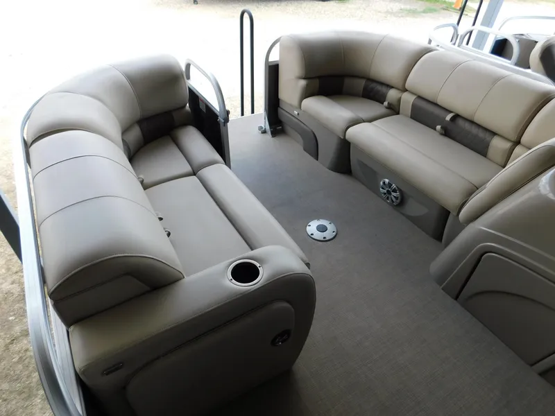 Slide: The Image of 2023 Sun Tracker Party Barge 22 RF DLX interior with plush seating and cup holders. - 9