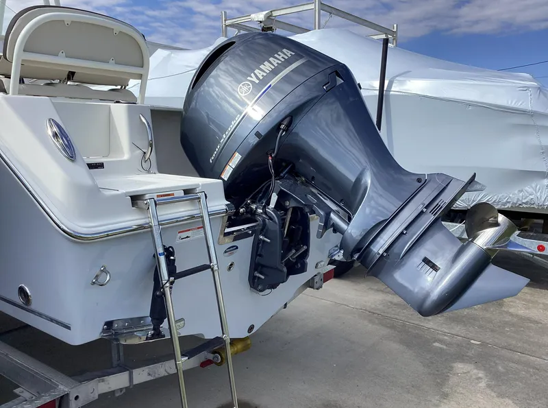 Slide: The Image of 2022 Sailfish 220 CC boat with Yamaha outboard motor, docked on a trailer. - 1