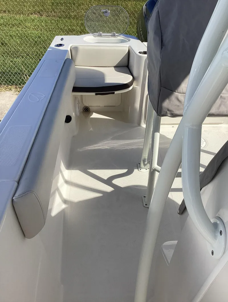 Slide: The Image of 2022 Sailfish 220 CC boat interior with seating and railing. - 11