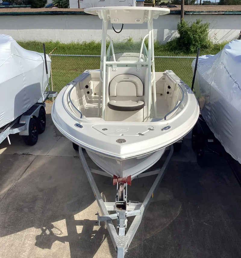 Slide: The Image of 2022 Sailfish 220 CC boat on trailer, parked outdoors. - 12