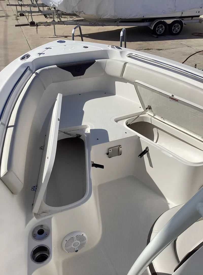 Slide: The Image of 2022 Sailfish 220 CC boat interior with open storage compartments. - 15