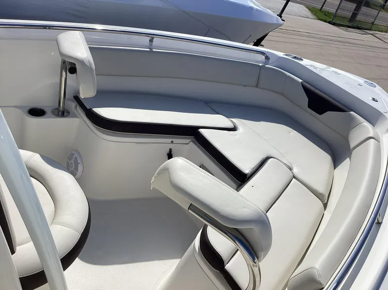 Slide: The Image of 2022 Sailfish 220 CC boat interior with white cushioned seating. - 17