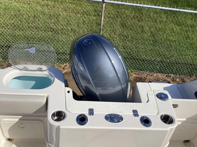 Slide: The Image of 2022 Sailfish 220 CC boat with outboard motor and fishing rod holders. - 7