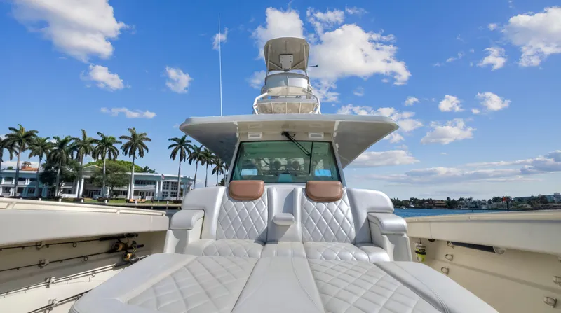 Slide: The Image of 2018 HCB 53 Sueños luxury yacht with plush seating and scenic waterfront view. - 19