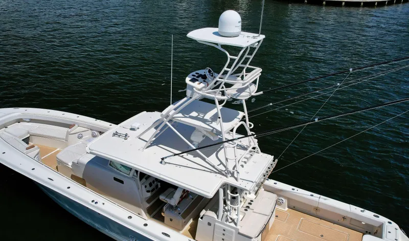 Slide: The Image of 2018 HCB 53 Sueños boat with upper deck, docked on calm water. - 4