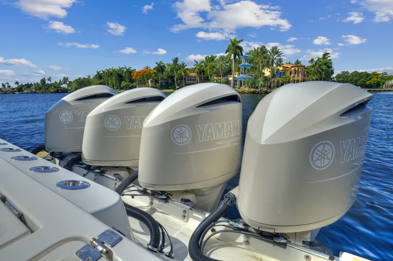 Slide: The Image of Four Yamaha outboard engines on a 2018 HCB 53 Sueños boat, scenic waterfront background. - 5