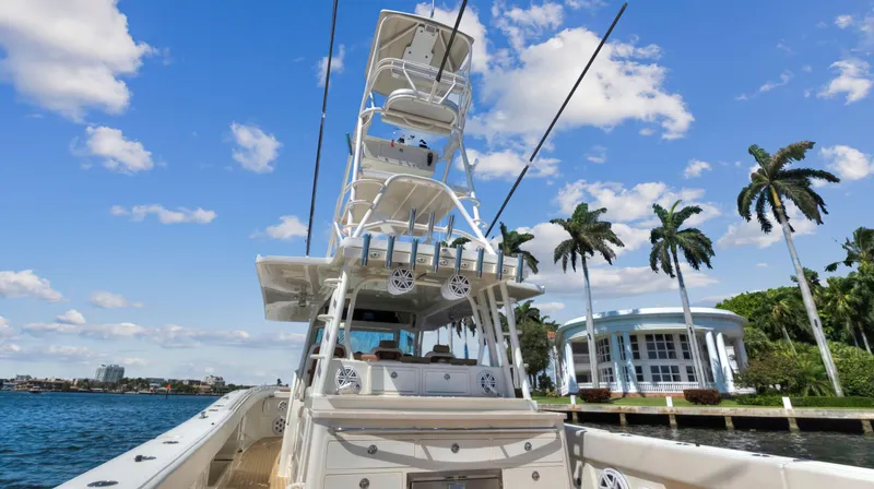 Slide: The Image of 2018 HCB 53 Sueños boat cruising near waterfront homes and palm trees. - 10
