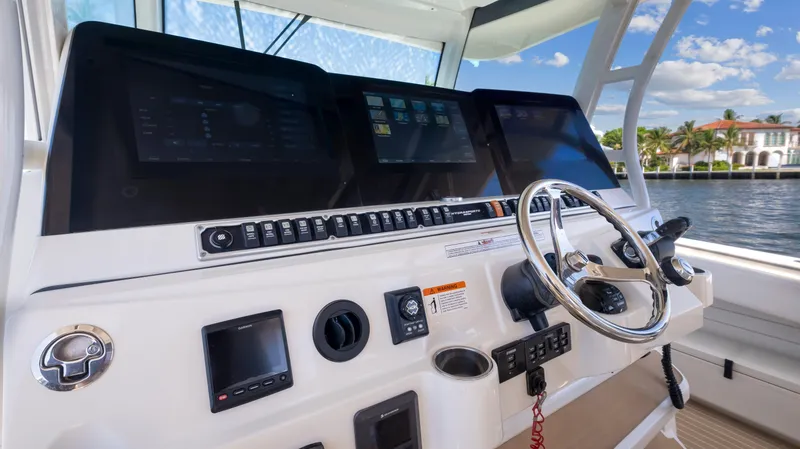 Slide: The Image of 2018 HCB 53 Sueños boat helm with advanced navigation systems and steering wheel. - 13