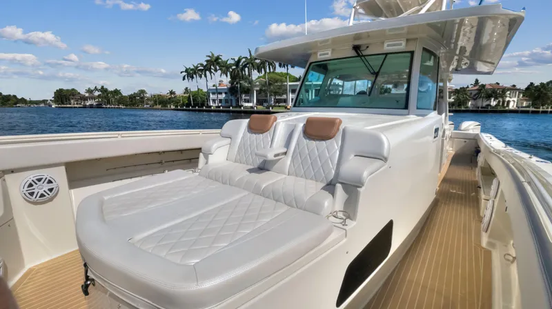 Slide: The Image of 2018 HCB 53 Sueños luxury boat with cushioned seating on deck. - 18