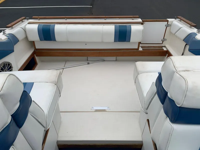 Slide: The Image of 1989 Sea Ray 230 Weekender boat interior with white and blue seating. - 8