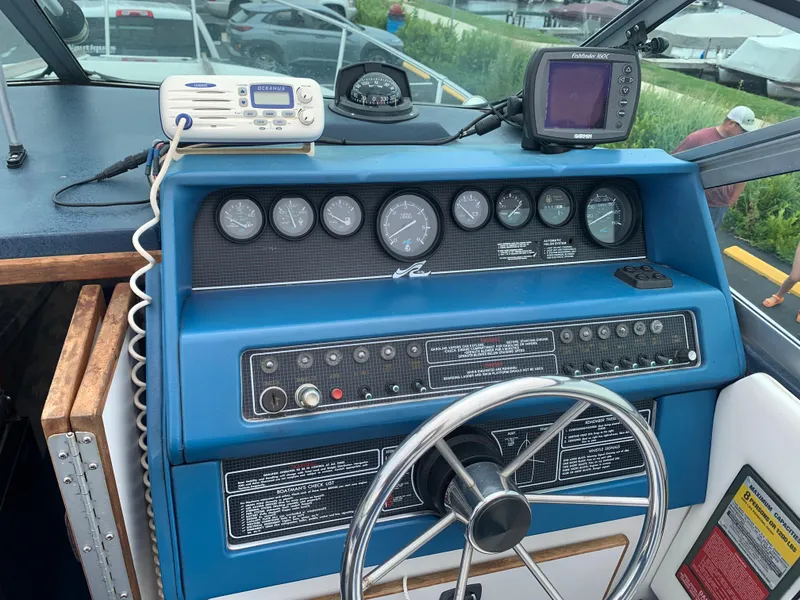 Slide: The Image of Control panel of a 1989 Sea Ray 230 Weekender boat with steering wheel and gauges. - 9