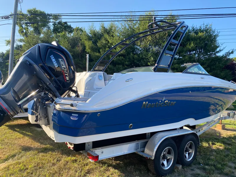 Slide: The Image of 2023 NauticStar 243DC Sport Deck boat on trailer with Yamaha outboard motor. - 7