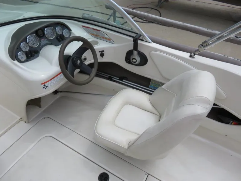 Slide: The Image of 2006 Sea Ray 175 Sport boat interior with steering wheel and white captain's seat. - 4