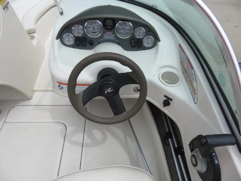 Slide: The Image of Steering console of a 2006 Sea Ray 175 Sport boat with gauges and controls. - 5