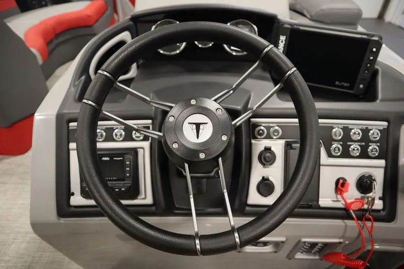 Slide: The Image of 2023 Trifecta 23SB2 SS 3.0 boat steering wheel and dashboard controls. - 30