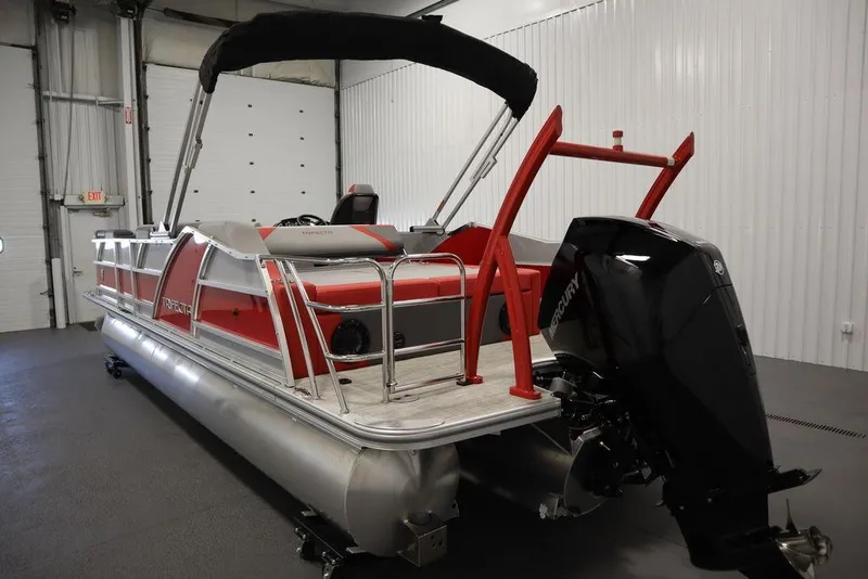 Slide: The Image of 2023 Trifecta 23SB2 SS 3.0 pontoon boat with red and silver accents in a showroom. - 5