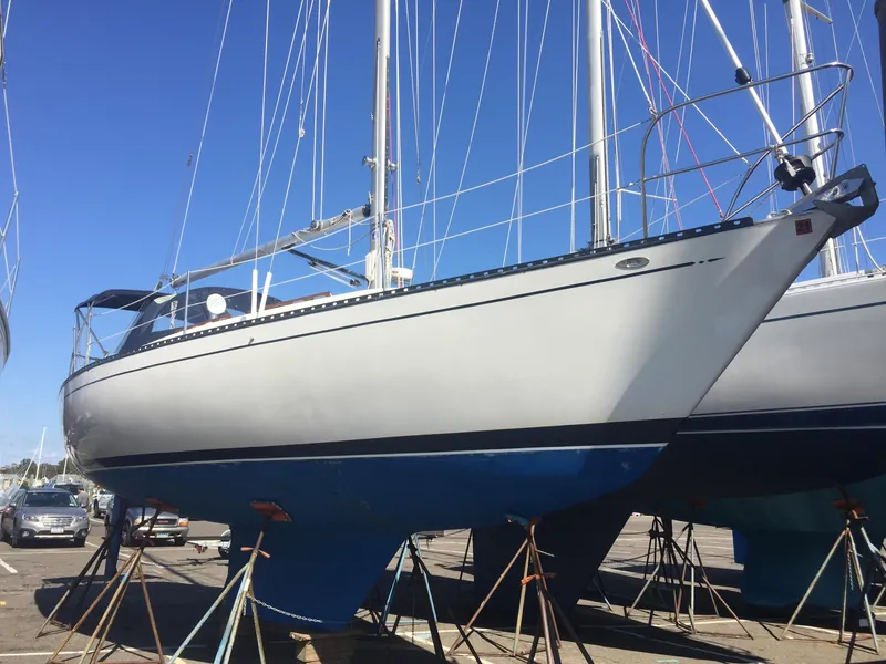 Slide: The Image of 1980 Tartan 33 sailboat on stands in a boatyard. - 0