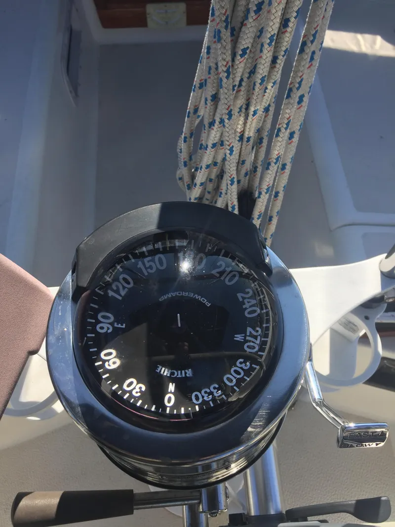 Slide: The Image of Compass on a 1980 Tartan 33 sailboat with coiled ropes in the background. - 12