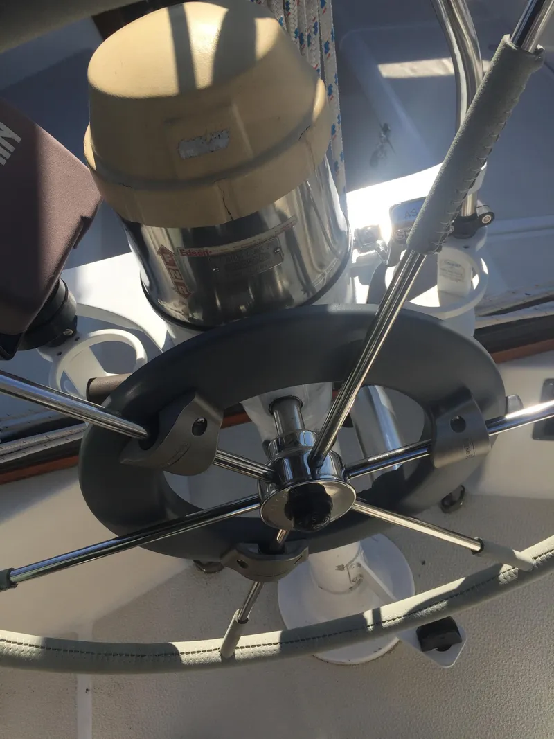 Slide: The Image of Steering wheel and compass of a 1980 Tartan 33 sailboat. - 13