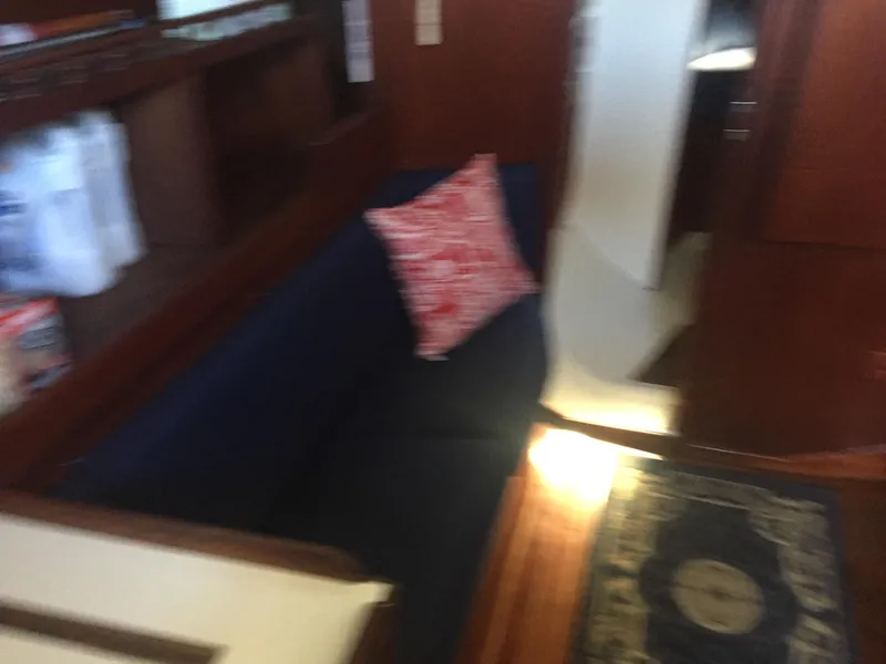 Slide: The Image of Interior of 1980 Tartan 33 sailboat with blue seating and red pillow. - 14