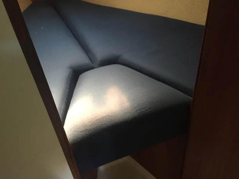 Slide: The Image of V-berth with blue cushions in a 1980 Tartan 33 sailboat. - 21