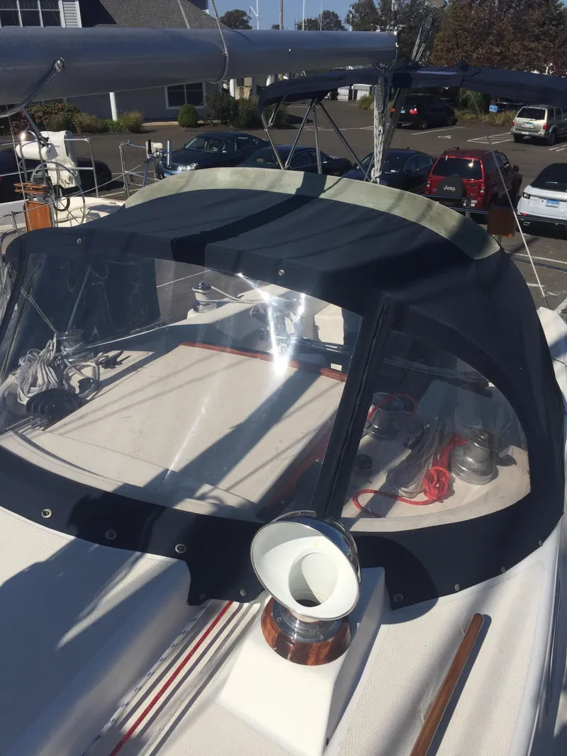 Slide: The Image of 1980 Tartan 33 sailboat with cockpit cover and winch in marina. - 7