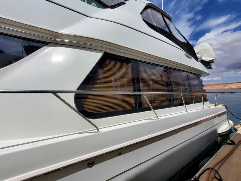 Slide: The Image of 2003 Carver 570 Voyager Pilothouse yacht side view with windows and railing. - 16