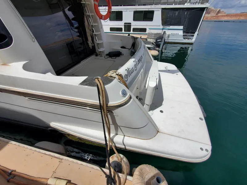 Slide: The Image of 2003 Carver 570 Voyager Pilothouse docked, rear view with swim platform. - 17