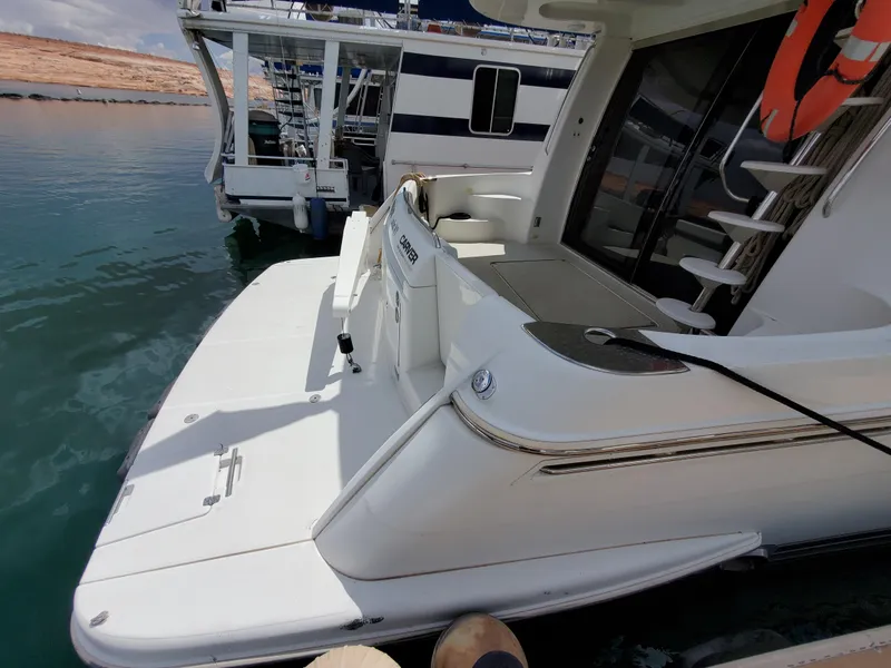 Slide: The Image of 2003 Carver 570 Voyager Pilothouse yacht docked at marina. - 18