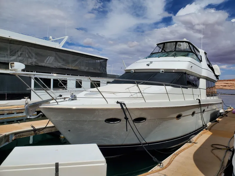 Slide: The Image of 2003 Carver 570 Voyager Pilothouse yacht docked at marina. - 3