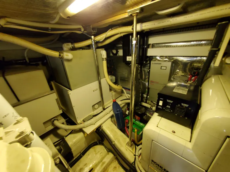 Slide: The Image of Engine room of a 2003 Carver 570 Voyager Pilothouse yacht with various mechanical components. - 33